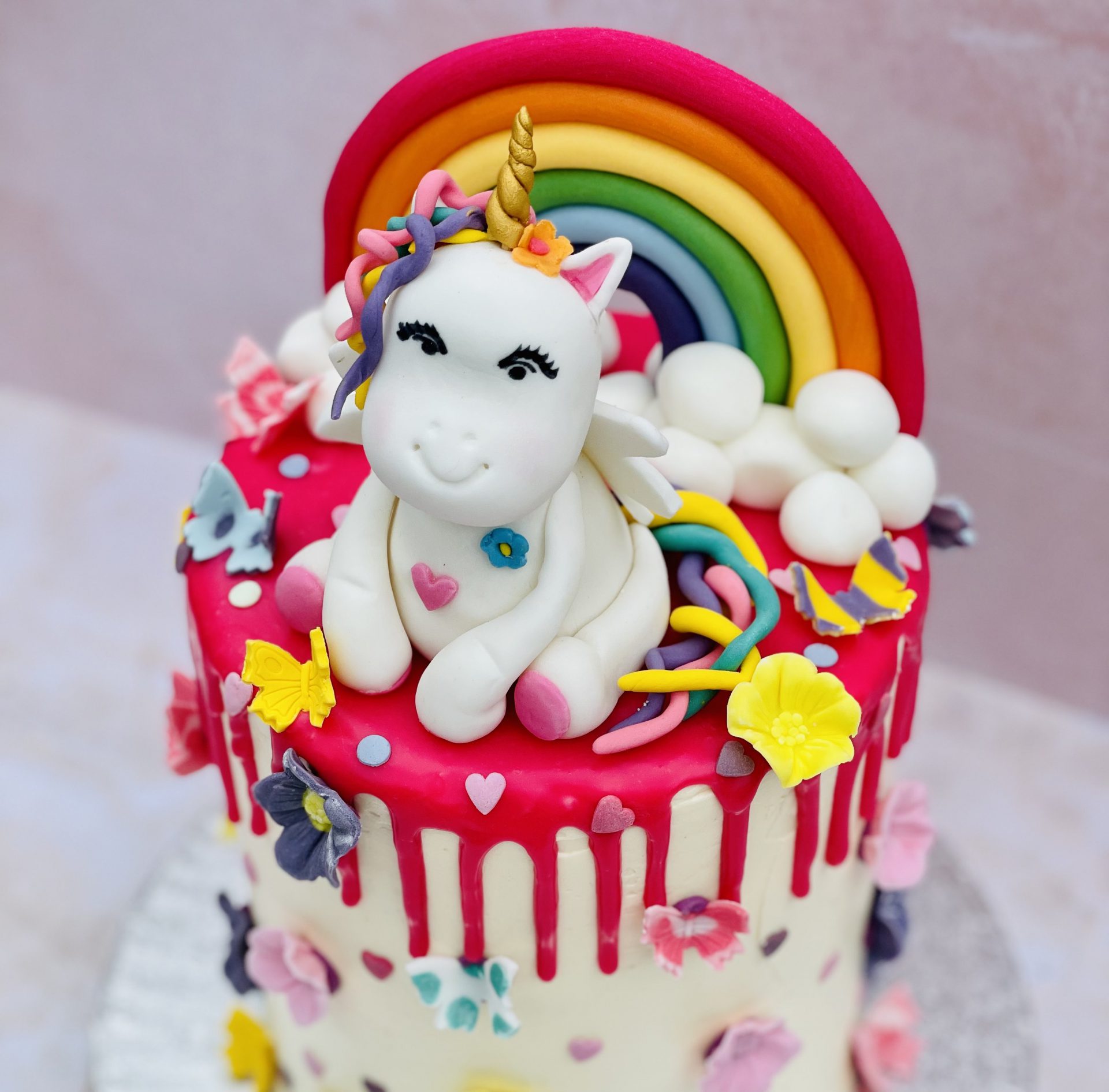 Cute unicorn cake with painted closed eyes on wooden table on dark  background — golden, party - Stock Photo | #297138348